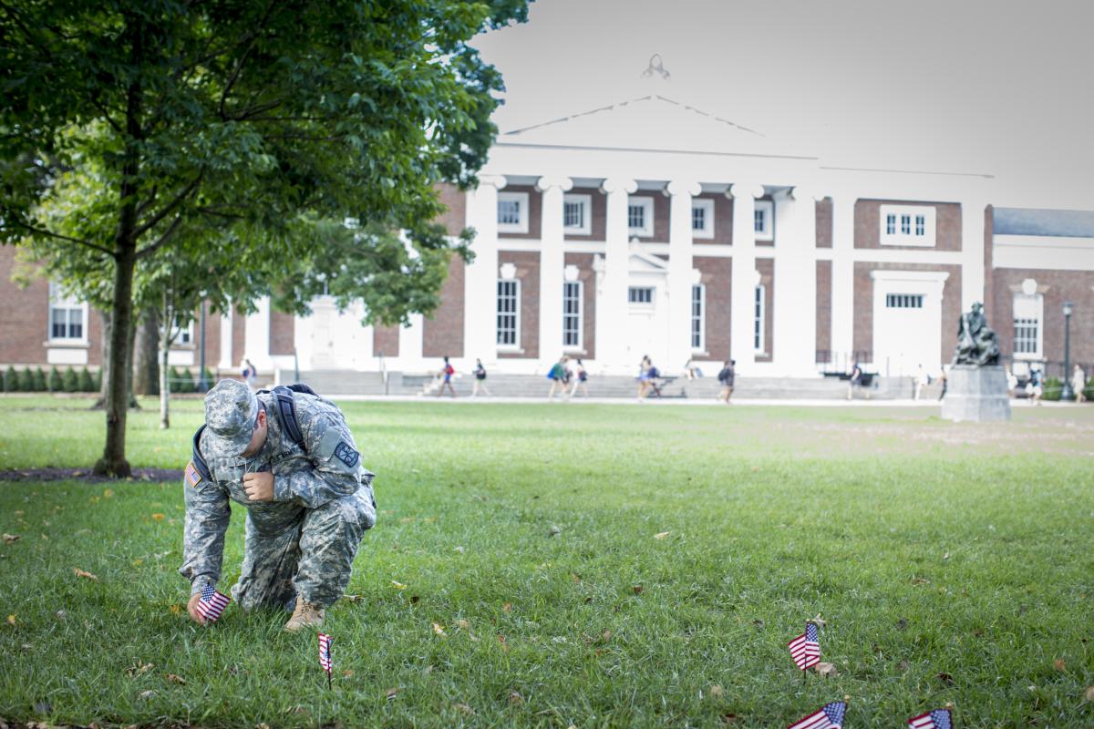 An image of a ROTC student placing flags on the UVA Lawn