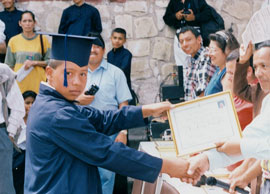 young boy receiving diploma