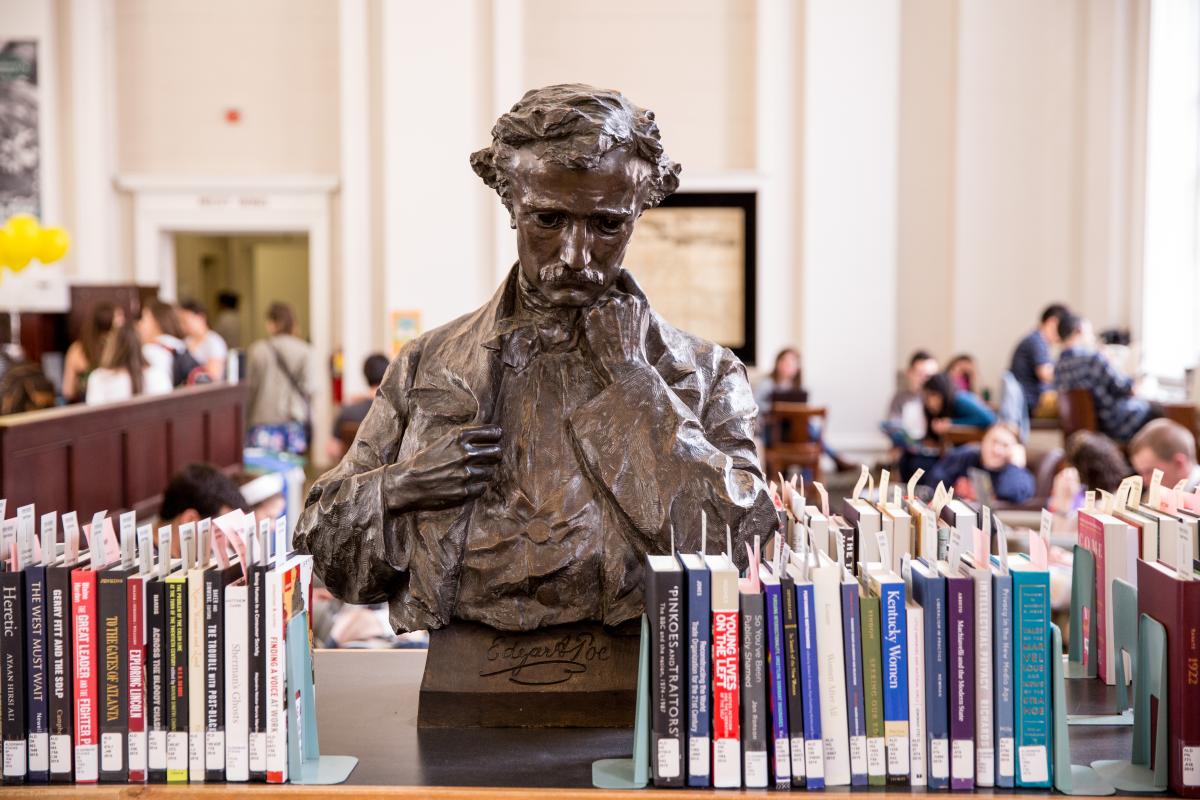 Bust of Egdar Allen Poe surrounded by books